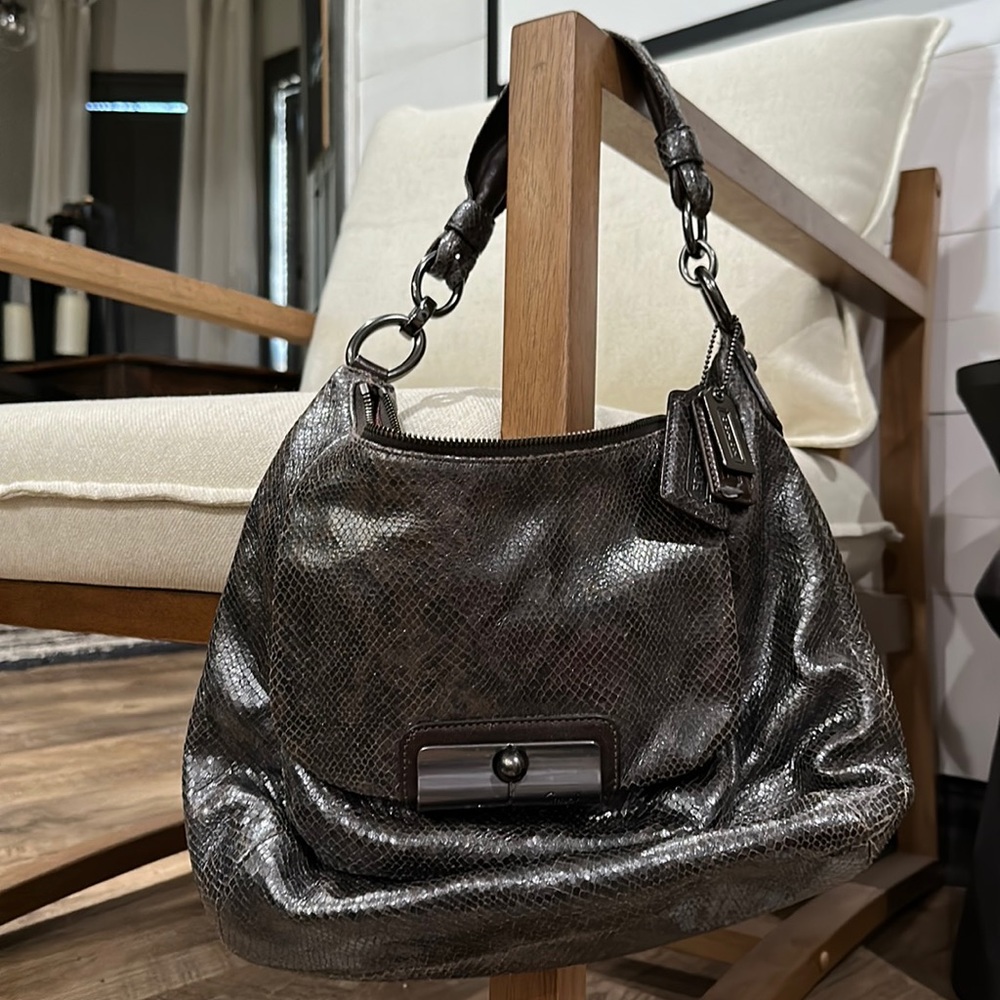 Brown and grey Coach purse with snack embossing